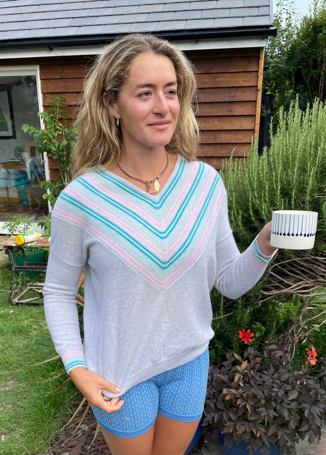 Designer Cocoa Cashmere V with dark and light turquoise and pink stripes delineating the V, also on ribbing of cuffs, side slits, 44”, L (excellent condition)